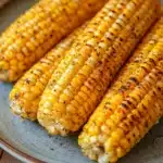 Close-up of air fryer corn on the cob with golden kernels and a clean background