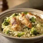 Close-up of Broccoli Cheddar Chicken Orzo with creamy sauce and herbs