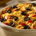Close-up of a delicious chicken tortilla casserole with melted cheese and crispy tortilla strips.