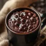 Close-up of a chocolate cake in a mug with a rich, moist texture, perfect for a quick microwave dessert.