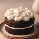 Close-up of a chocolate cake with rich textures and a clean background, perfect for dessert lovers.