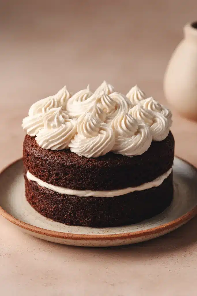 Close-up of a chocolate cake with rich textures and a clean background, perfect for dessert lovers.