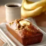 Close-up of coffee cake banana bread with crumbly topping and warm lighting