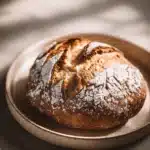 Close-up of freshly baked bread with a golden crust made with bread flour.