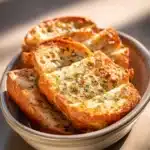 Close-up of golden garlic bread with a crispy crust and soft interior