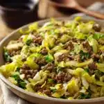 Close-up of a vibrant ground beef and cabbage stir fry with bright colors and clean background