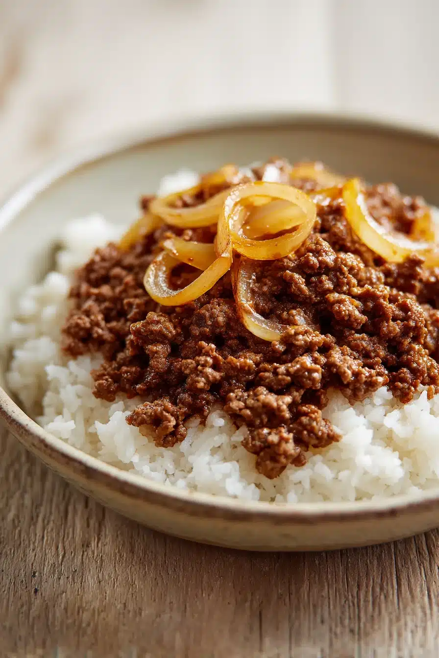 Close-up of a delicious ground beef dish cooked on the stove top, garnished with herbs.