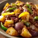 Close-up of a delicious ground beef hash with vibrant vegetables and herbs.