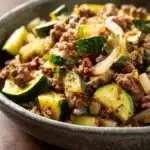 Close-up of a delicious ground beef zucchini dish with vibrant colors and textures.