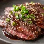Close-up of high protein Korean BBQ beef with bright, warm lighting and sharp textures.