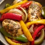 Close-up of Instant Pot chicken and peppers with vibrant colors and clear textures.