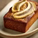 Close-up of peanut butter banana bread with a golden crust and moist texture.
