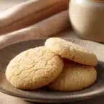 Close-up of sugar cookies with golden brown edges on a white background.