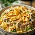 Close-up of a creamy tuna casserole with golden crust and herbs