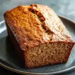 Close-up of banana bread without eggs on a wooden board with a clean background