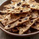 Close-up of crispy cookie brittle with a golden brown texture on a clean background