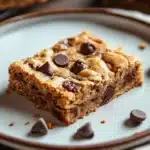 Close-up of a gluten-free cookie bar with chocolate chips and a golden crust.