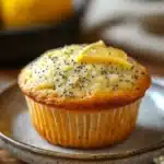 Close-up of a lemon poppyseed muffin sourdough with a golden crust and poppy seeds.
