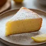 Close-up of a lemon zest cake slice with bright lighting and clean background