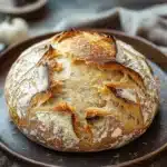 Close-up of golden-brown no knead bread made with active dry yeast on a clean surface