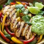 Close-up of skillet chicken fajitas with creamy jalapeño verde sauce, vibrant and appetizing.