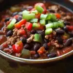Close-up of slow cooker black bean taco chili with vibrant colors and textures