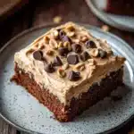 Close-up of a delicious peanut butter zucchini sheet cake with a creamy topping.