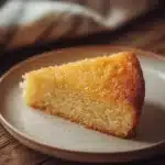 Close-up of a vanilla cake with a light, fluffy texture and no butter visible.