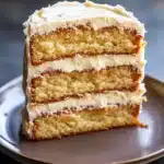 Close-up of a vanilla cake with filling, showcasing layers and creamy texture