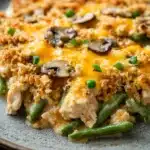 Close-up of chicken casserole with green beans in a warm, inviting setting.