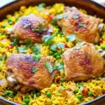 Close-up of a chicken yellow rice skillet with vibrant colors and appetizing presentation.