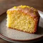 Close-up of a lemon cake slice with bright, natural lighting and minimal background.