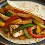 Close-up of low calorie chicken fajita with colorful peppers and onions